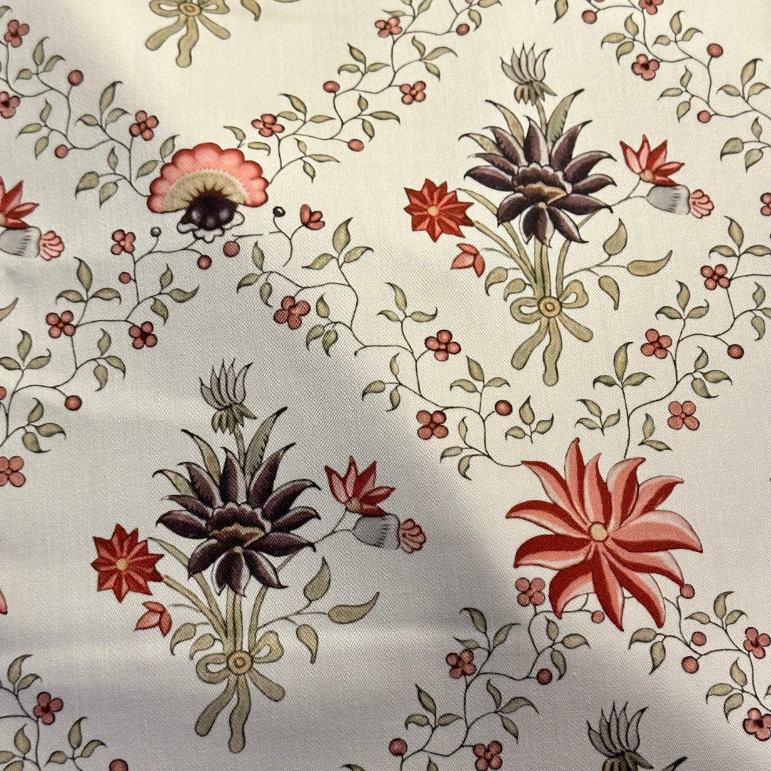 Floral patterned fabric with red, brown, and green flowers on a light background