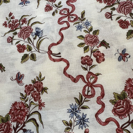 Floral and ribbon pattern on a textured fabric background