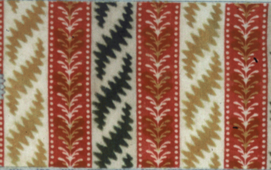 Textile sample with a striped pattern featuring red, beige, black, and white.