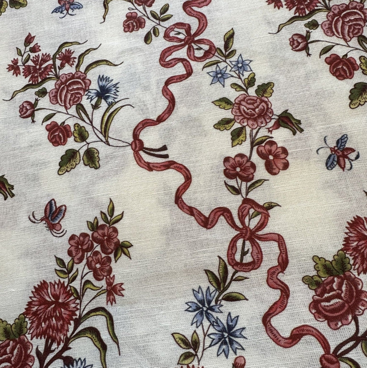 Floral and ribbon pattern on a textured fabric background